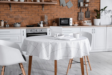 Dining table in interior of modern kitchen