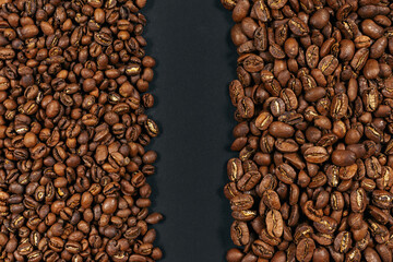 Roasted coffee beans. Two sorts of arabica on black background