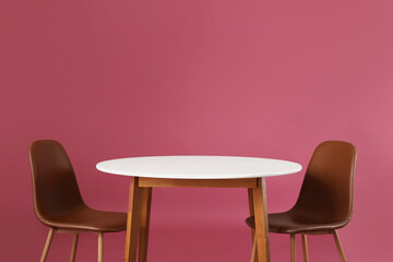 Dining table with chairs on color background