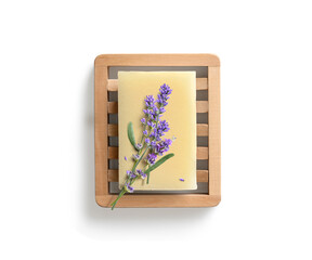 Homemade lavender soap on wooden soap dish isolated on white background. Directly above