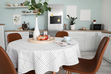 Dining table in interior of modern kitchen