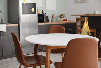 Dining table in interior of modern kitchen