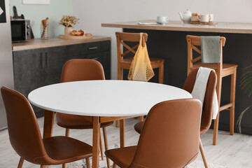 Dining table in interior of modern kitchen
