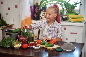 The child helps to prepare vegetables for the winter, home canning . Cooking at home .