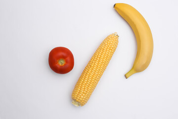 Fototapeta na wymiar Swing of corn, tomato and banana on white background. Top view