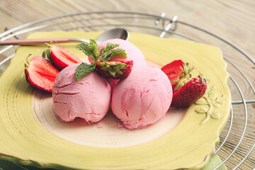 Plate with tasty strawberry ice cream on table, closeup