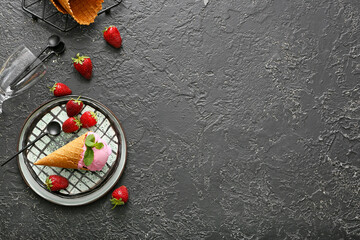 Plate with tasty strawberry ice cream on dark background