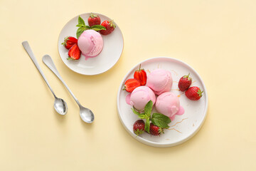 Plates with tasty strawberry ice cream on color background
