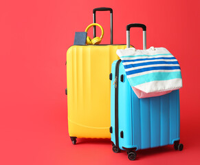 Packed suitcases with accessories on color background. Travel concept