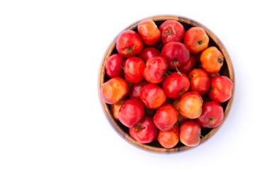 red acerola cherry fruit in wooden bowl isolated on white background. Top view.