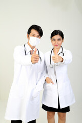 Young Asian male female doctor wearing apron stethoscope thumbs up