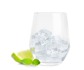 Glass with ice cubes, lime and mint on white background