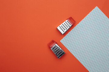 Mini graters on orange blue background. Top view