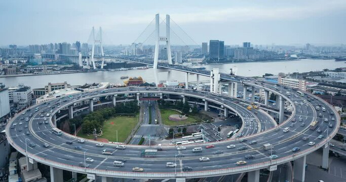 time lapse of  traffic stream on shanghai nanpu bridge in rush hour, the chinese text on the bridge tower is "nanpu bridge"