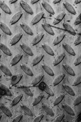 evocative black and white image of metal plate texture with abstract relief patterns