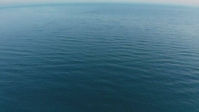 Top view of dark blue ocean water and surface . Aerial drone shot over the sea