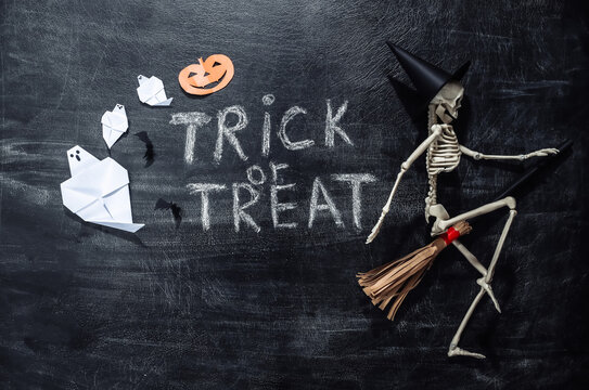 Movie Clapperboard and Chalk lettering Trick or treat on a chalk board with helloween decor. Halloween theme
