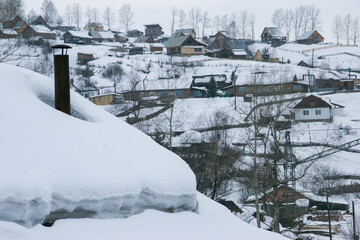 Spring in the Altai Mountains. Snow-covered mountain village. Altai Krai, Russia.