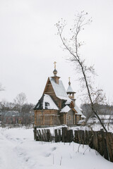 Spring in the Altai Mountains. Snow-covered mountain village. Orthodox church. Altai Krai, Russia.