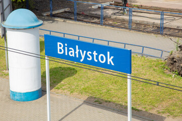 The inscription Białystok on the sign next to the station