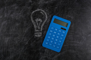 Calculator with a painted light bulb on chalk board