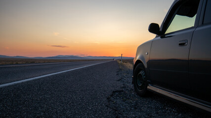 Fototapeta na wymiar desert sunset with car in foreground