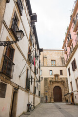 Fototapeta na wymiar Typical street in the historical old town center of San Sebastian (Donostia, Basque Autonomous Community, Spain). Beautiful architecture. Vertical shot, no tourisyts. 