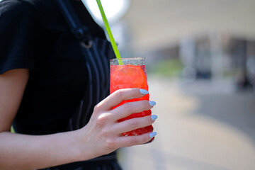 Hand holding smoothie shake cocktail. Drinking red healthy smoothie concept. Seasonal cocktail.