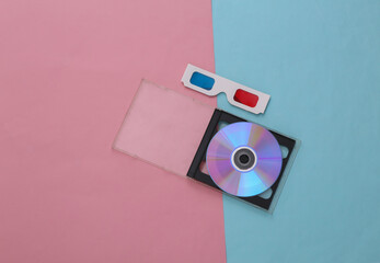 Compact disc with box, 3d glasses on pink blue pastel background. Top view