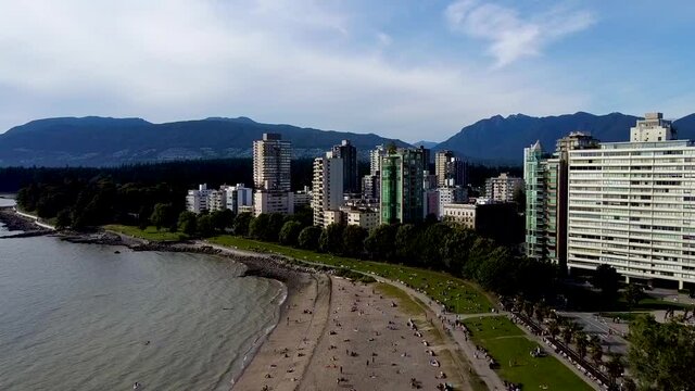 Aerial flyover English Bay to Stanley Park Posh VIP Condo Towers by the beach Mountain valley party place no so crowded for the summer of 2020 green park swimming beach suntainning walking jogging 2-2