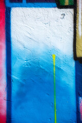 Abstract creative background of chaotic strokes of old cracked paint on concrete wall. Old surface with traces of paint, weathered, scratches and cracks for design