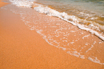 Tourist travel banner design template, copy space. White foam of a sea wave, golden sand beach, turquoise ocean water.