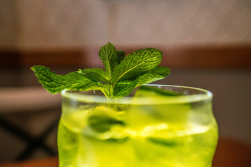 green and yellow drink with mint and ice