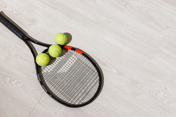 Tennis iquipment against a wooden background