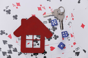 House figure and keys, dice on playing cards. Everything is at stake