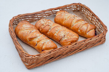  bun with cherries in a basket on a white background
