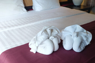 Fototapeta na wymiar White swan blanket origami decoration on the bed