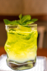 green and yellow drink with mint and ice