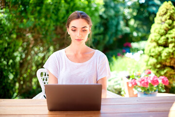 Attractive woman working at balcony at home