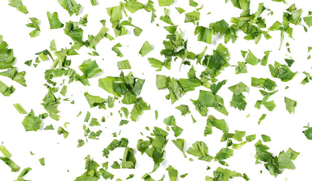 Fresh chopped up celery leaves pile isolated on white background, top view