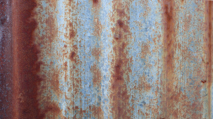 The old steel walls outside the rusty building are caused by rainwater and air.