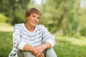 Naklejka na ściany i meble happy Senior caucasian woman relaxed outdoors. copy space