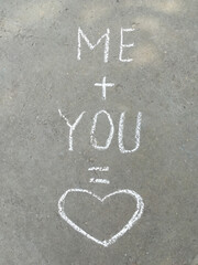 chalk inscription on the asphalt me plus you is love. heart, message, recognition, summer, wedding,...