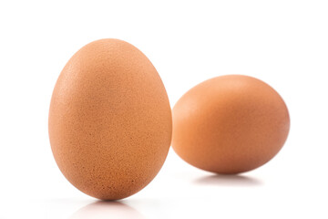 Two Brown chicken eggs isolated on white background.