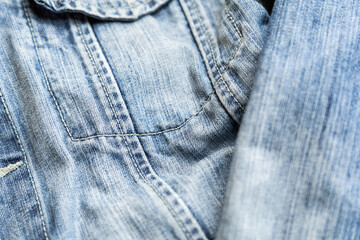 Fototapeta premium Detail of the pocket of a blue denim jeans. Blue denim jacket.