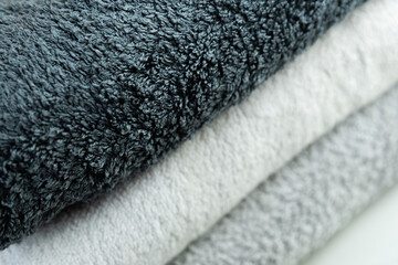 Background of the detail of a terrycloth towels in different shades of gray and white.