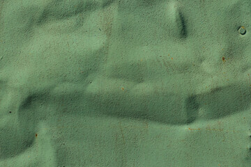 the texture of rusty tin, with already peeled and faded green paint.