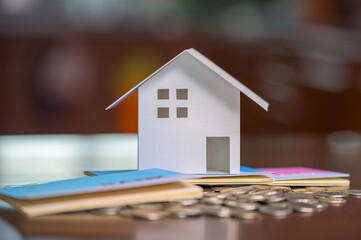 Model houses and stacked coins. Home equity loans. Mortgages and loans.