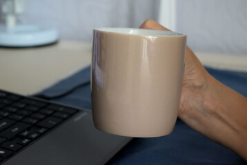 coffee mug and laptop, workplace
