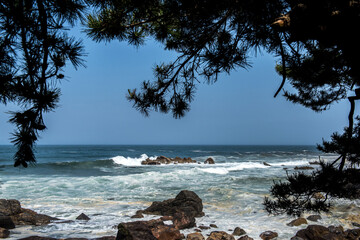 The big breaking waves during a strom at the beautiful summer sea shore background the blue sky and...